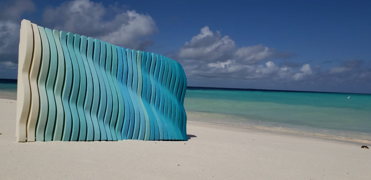 Blue sculptural artwork photographed on a beach in Los Roques.